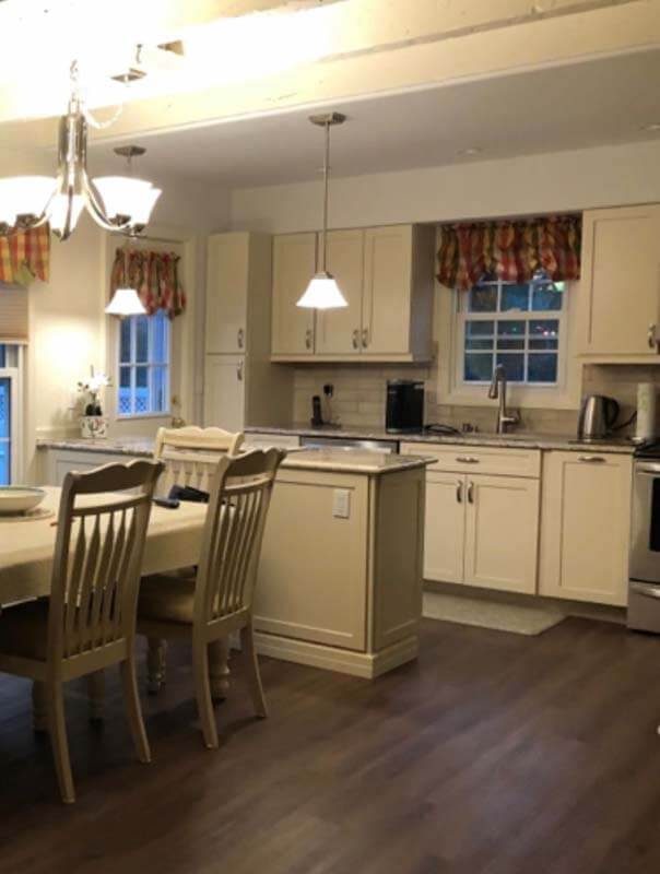 Cream kitchen with island and hardwood floors — West Babylon, NY