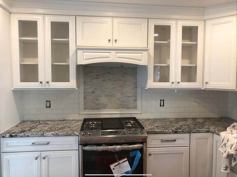 Custom kitchen cabinets with glass fronts and granite countertop — Bay Shore, NY