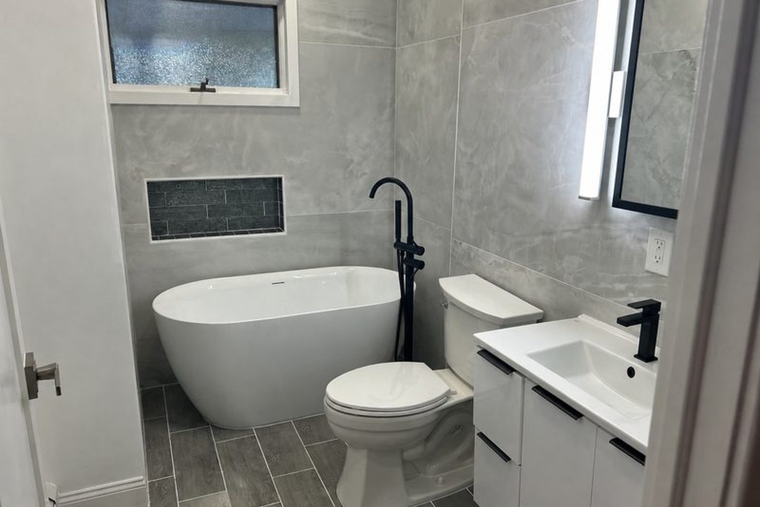 Renovated bathroom with new tile, vanity and freestanding tub on Long Island — Just Enterprise One Corp.