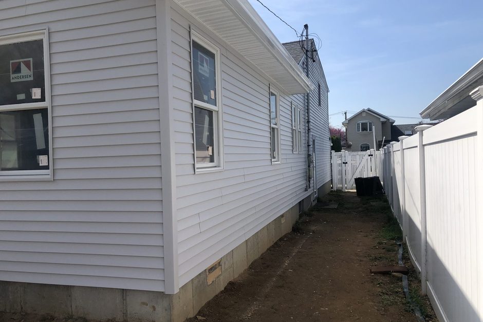 Siding, windows and gutter on the side wall of a Long Island home, Just Enterprise One Corp.