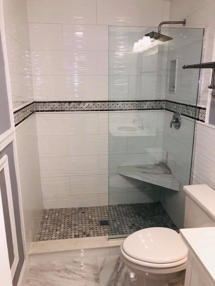 White subway tile shower with frameless glass door