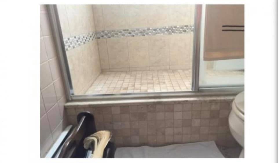Cream tiled walk-in shower with built-in niche