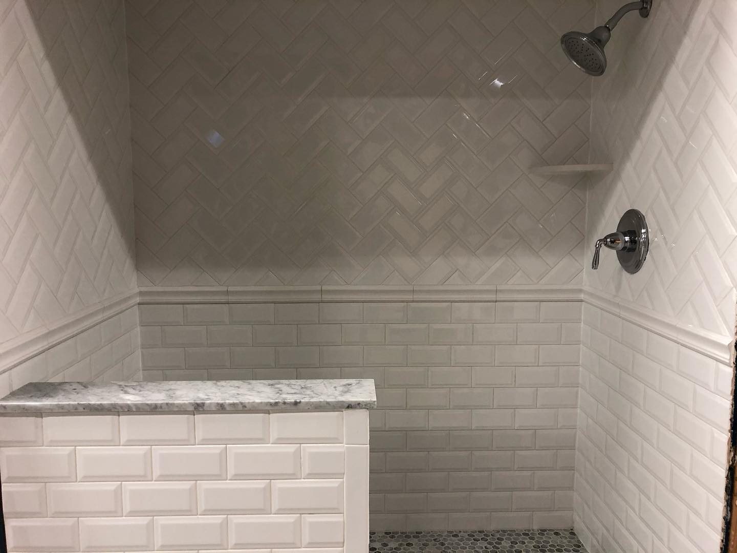 Full view of white tile shower with glass door