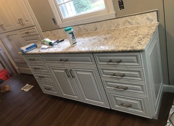 Bathroom vanity under construction — tile and plumbing rough-in