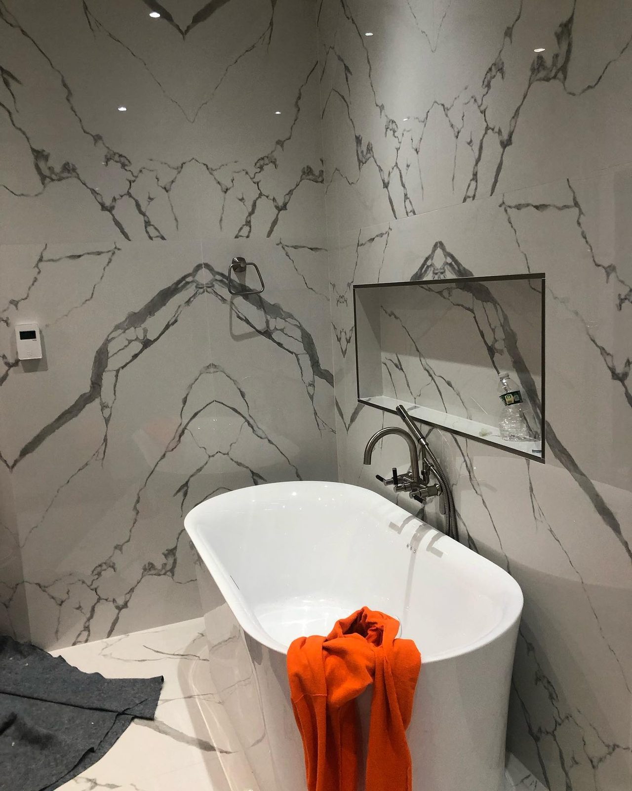 Marble shower detail with niche and rainfall showerhead