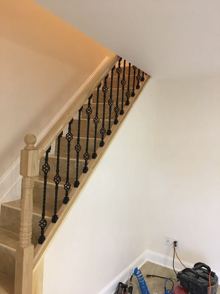 Interior staircase with decorative wrought iron basket balusters