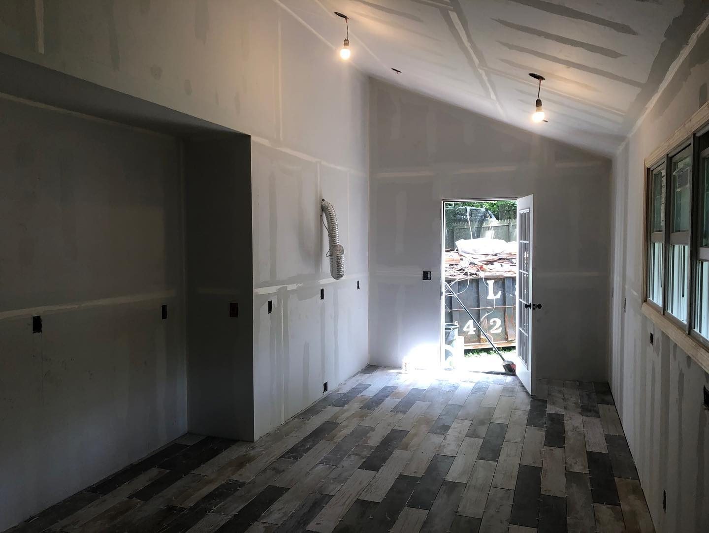 Room addition in progress with new tile floor installation