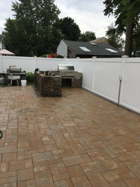 Paver patio with outdoor grill and dining area