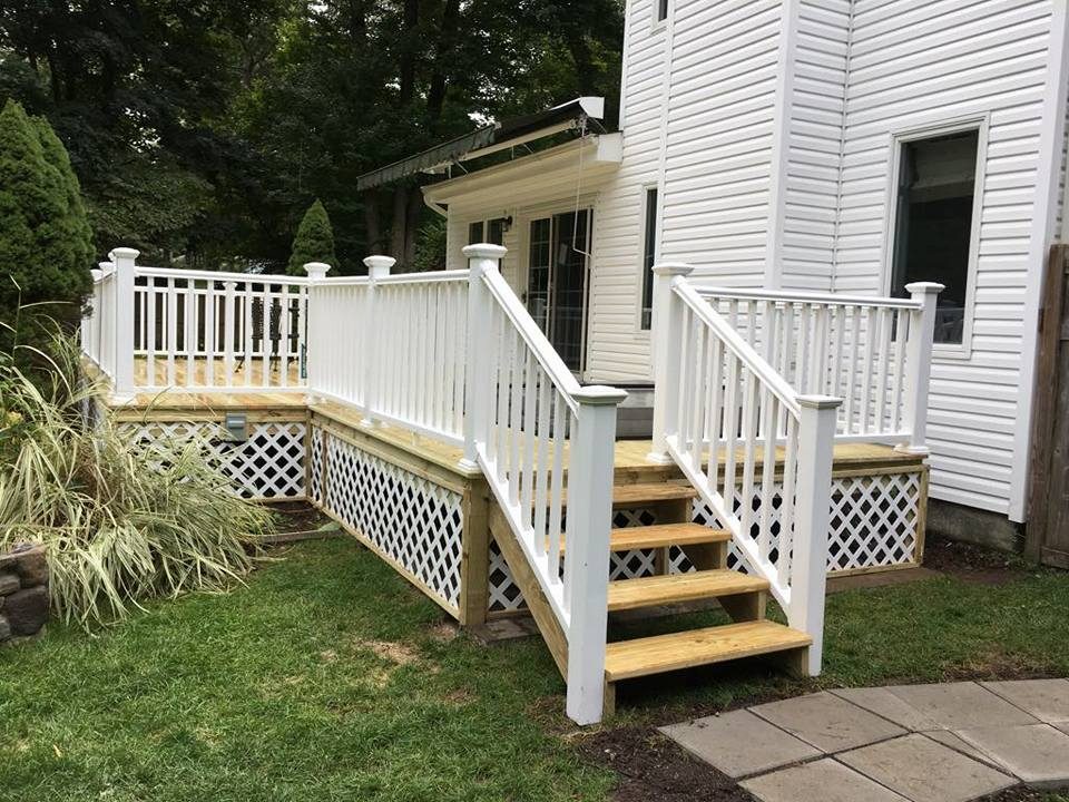 Deck staircase with lattice skirting and painted railings