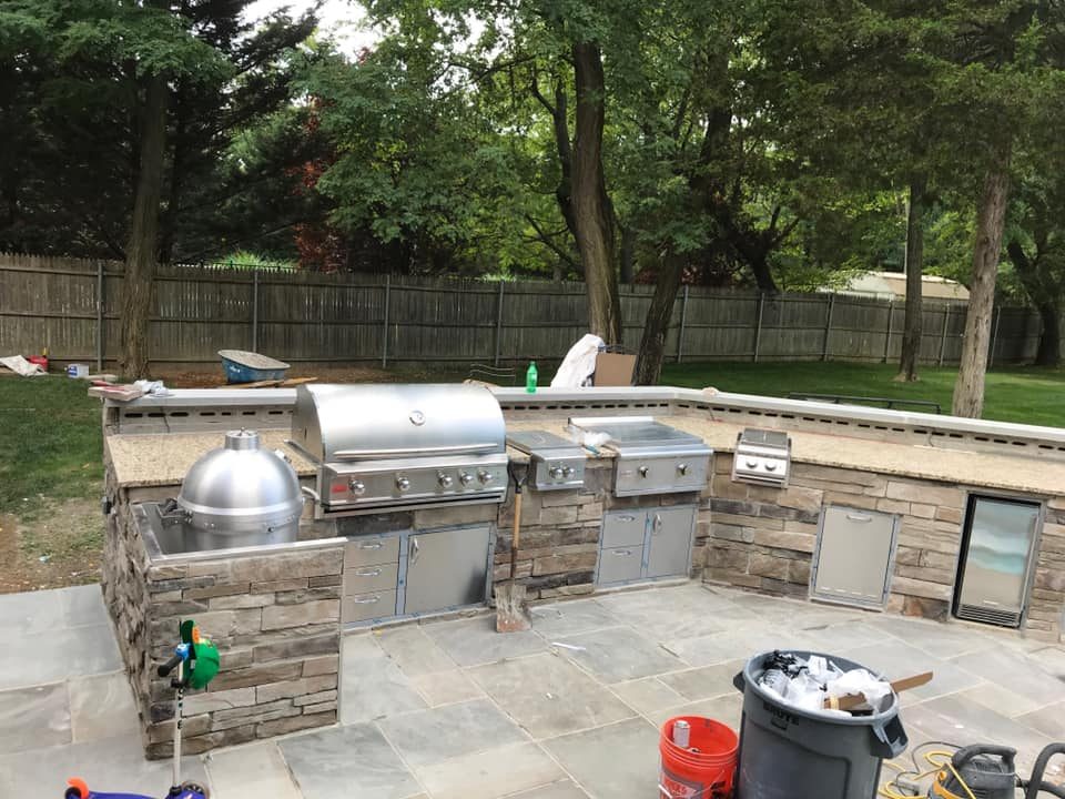 Stone veneer outdoor kitchen — alternate angle showing full layout