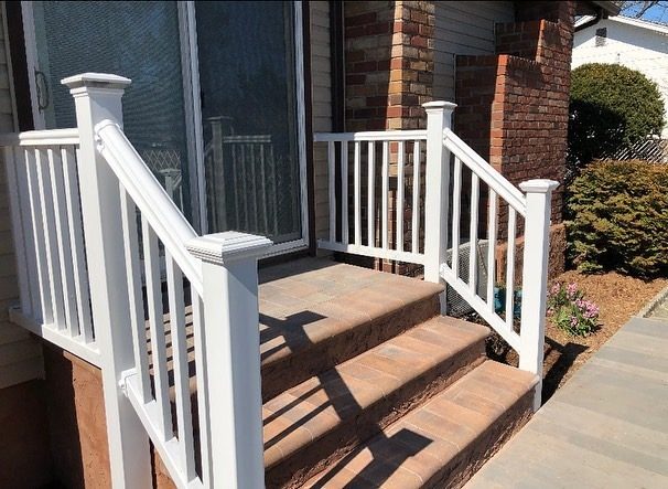 White vinyl railing on renovated front porch steps