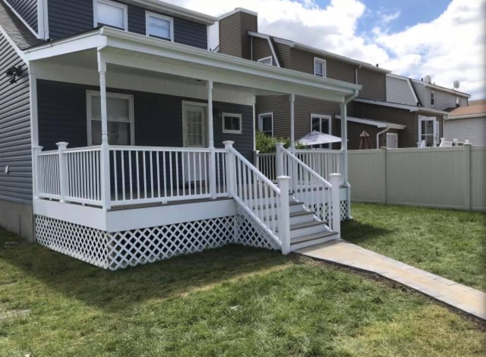 Covered front porch with white vinyl railings and columns