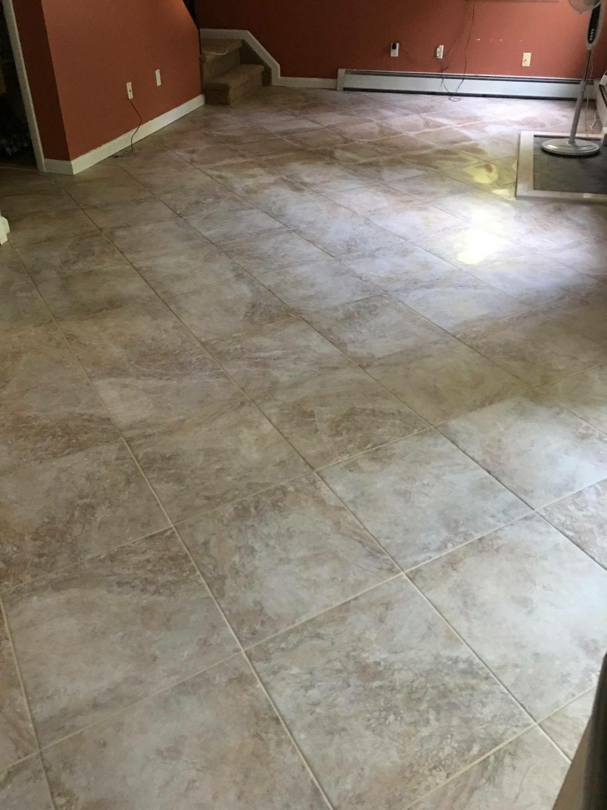 Large-format porcelain tile floor in finished basement