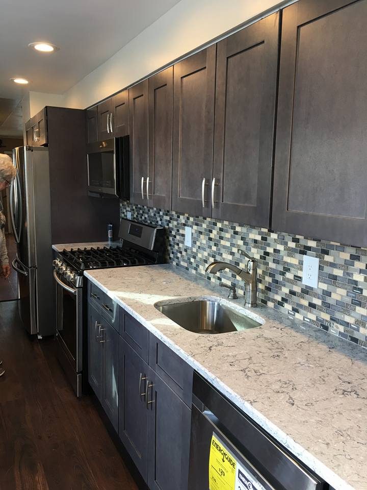 Dark gray charcoal shaker kitchen with glass mosaic backsplash