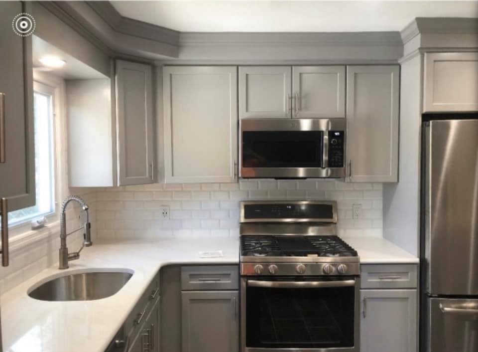 Gray shaker kitchen with subway tile backsplash and quartz countertops