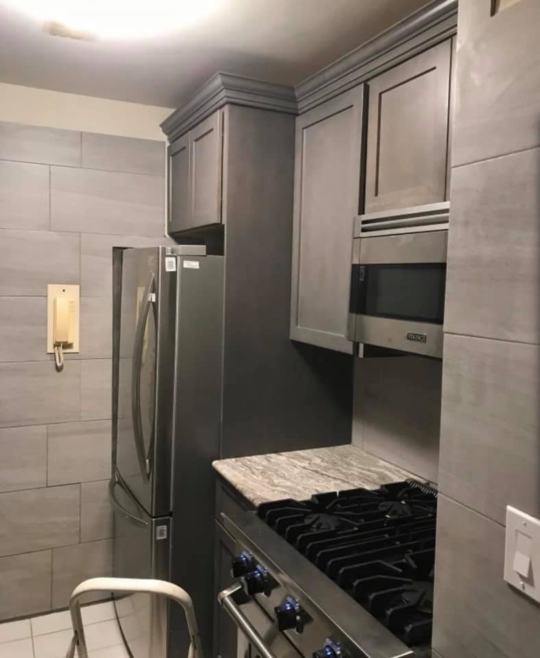 Dark espresso kitchen with built-in refrigerator and granite countertops