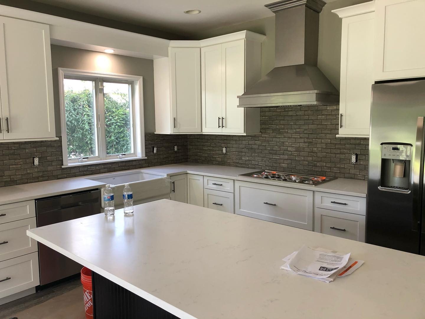 Kitchen renovation — view toward range with tile backsplash