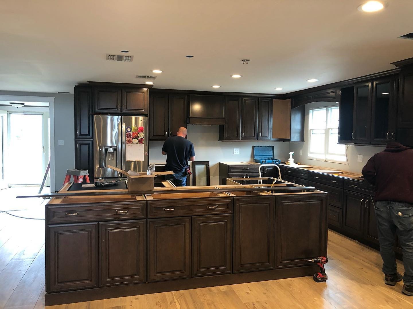 Dark espresso kitchen cabinet installation in progress