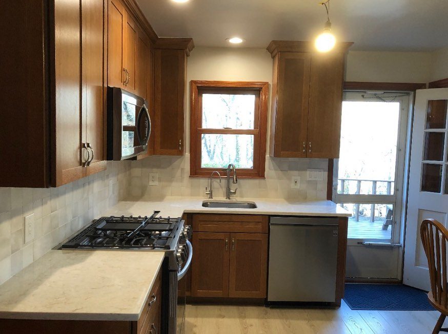 Medium oak kitchen renovation with granite countertops