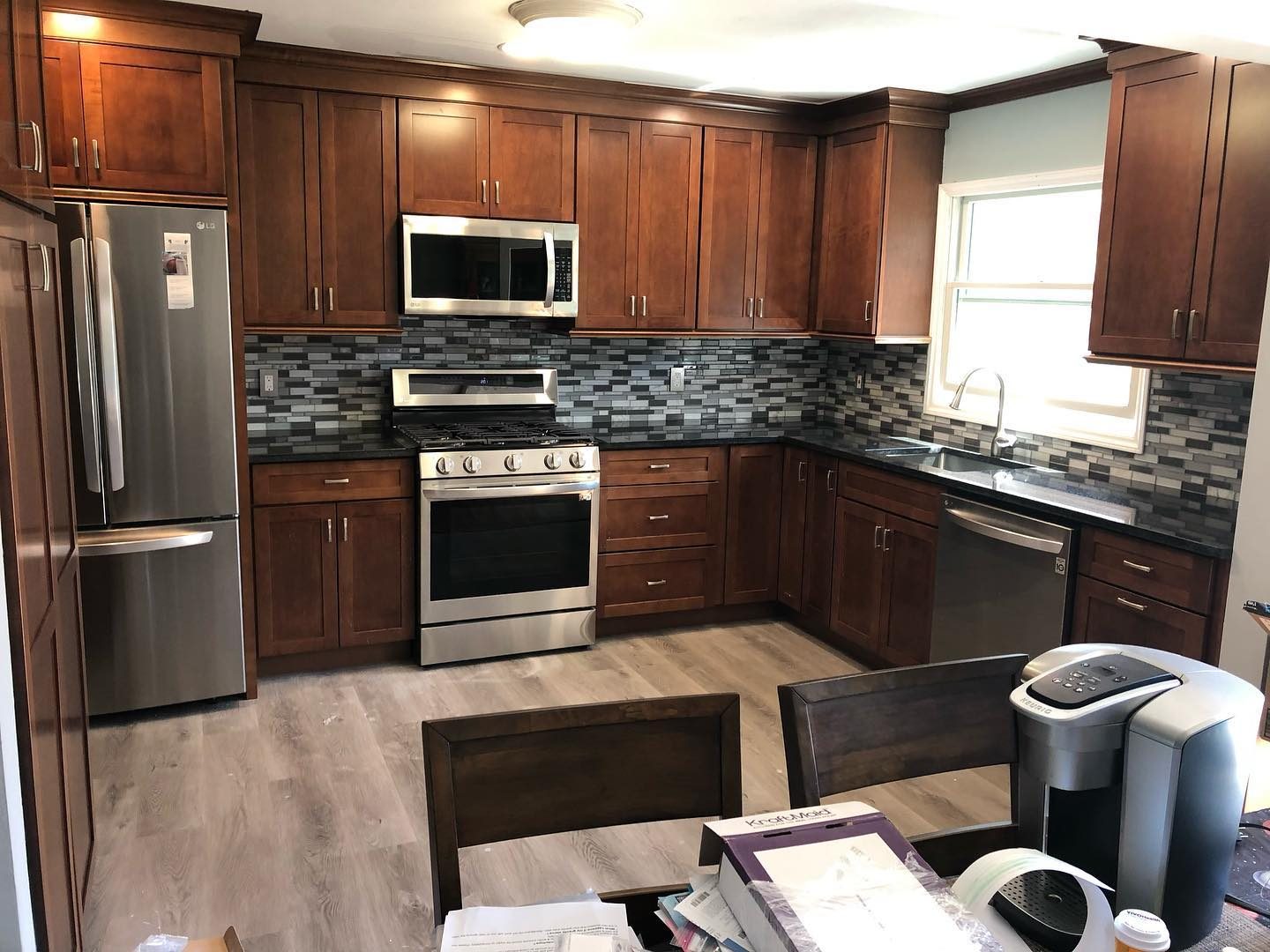 Oak and cherry kitchen with mosaic tile backsplash