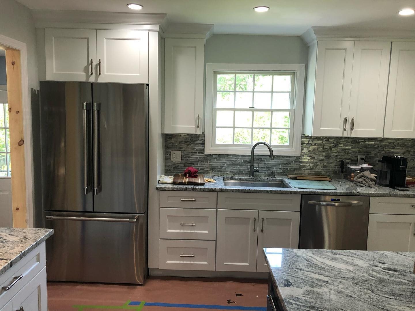 White kitchen with green and gray mosaic tile backsplash