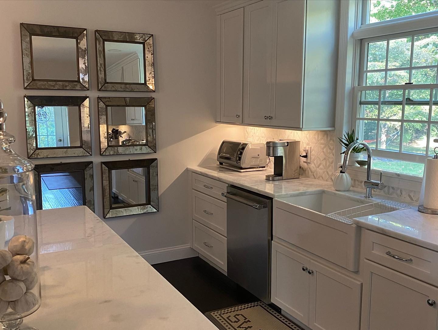 White shaker kitchen renovation with farmhouse sink and subway tile backsplash