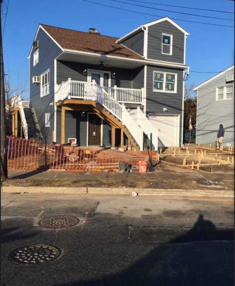 House exterior with gray LP SmartSide siding and elevated deck under construction