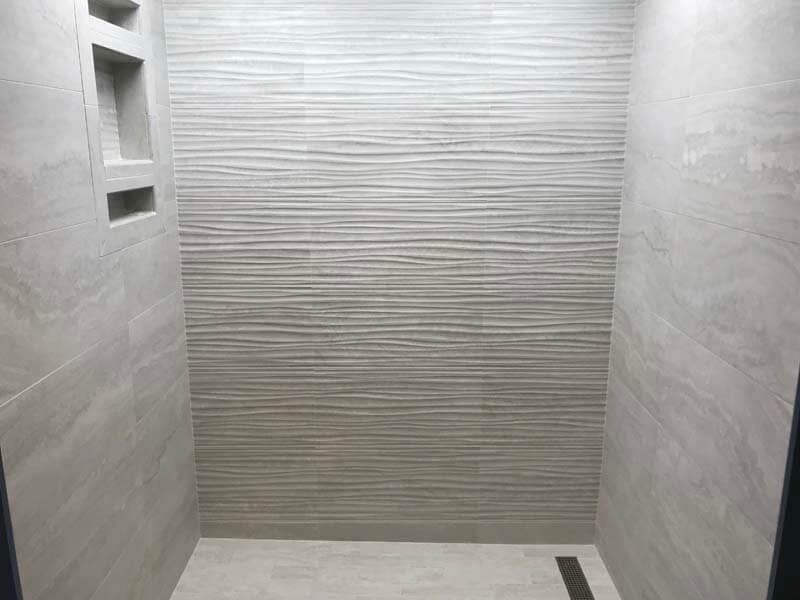Walk-in shower with textured wave tile walls — Smithtown, NY