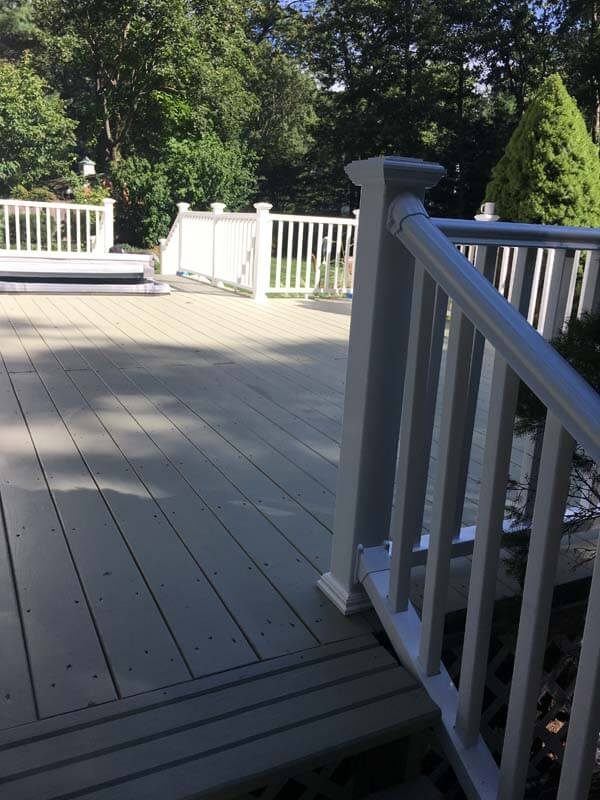 Composite deck with white PVC railings — Long Island, NY