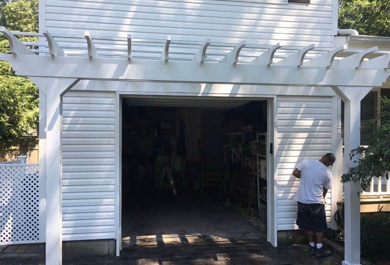 White vinyl siding on garage with pergola — Babylon, NY