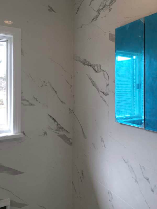 Marble panel walls and window in bathroom remodel — Northport, NY
